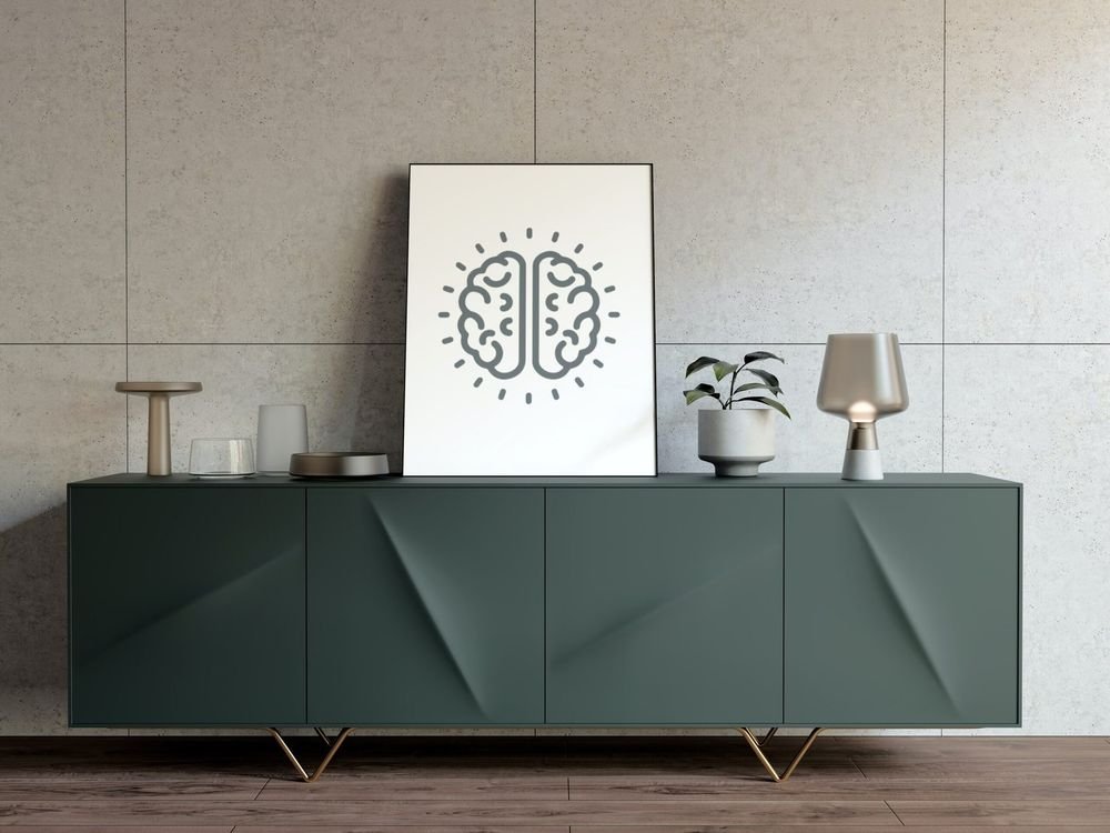 The brain mark print on a green sideboard against concrete panels
